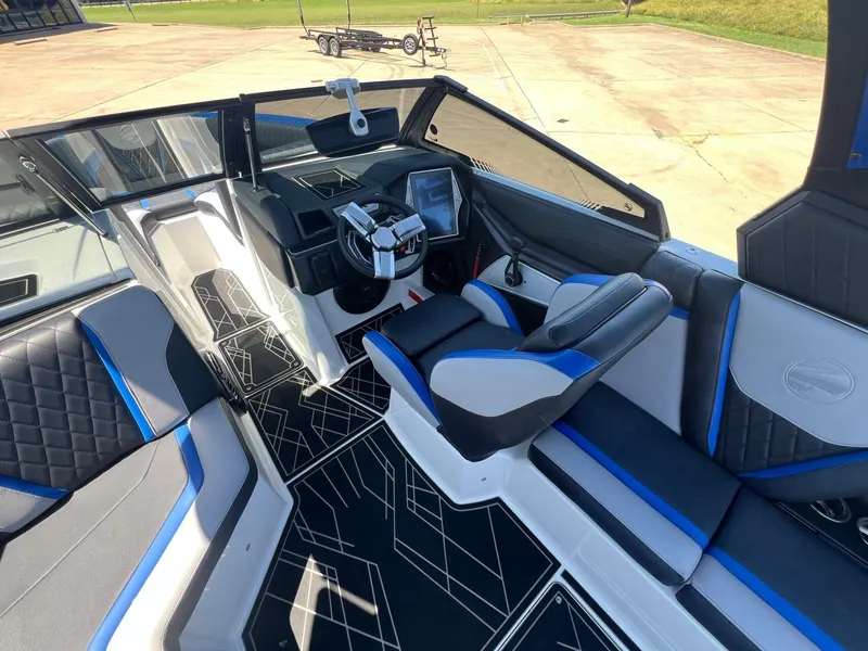 Slide: The Image of 2023 Tigé 25ZX boat interior with modern dashboard and stylish seating. - 13