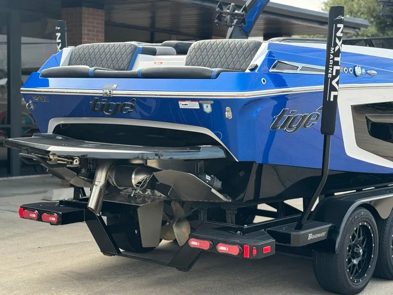 Slide: The Image of 2023 Tigé 25ZX boat rear view, showcasing propeller and sleek blue design. - 5