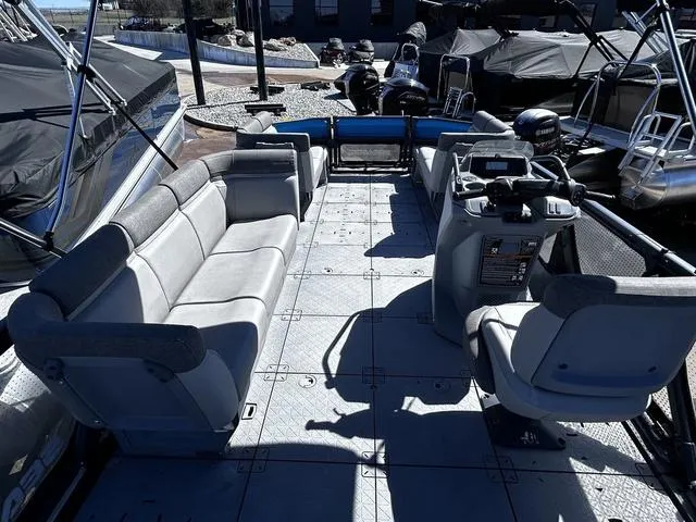 Slide: The Image of 2023 Sea-Doo Switch® 19-170 hp pontoon boat interior with spacious seating and helm. - 13