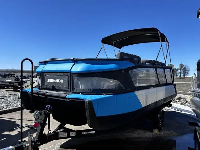Slide: The Image of 2023 Sea-Doo Switch® 19-170 hp pontoon boat on trailer, blue and black design. - 6