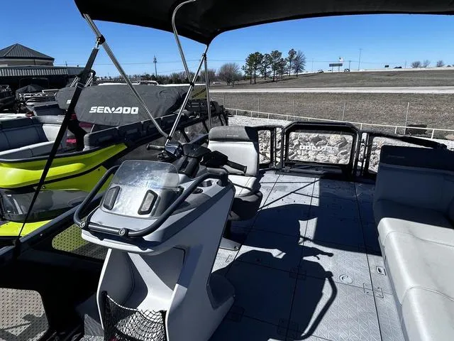 Slide: The Image of 2023 Sea-Doo Switch® 19-170 hp pontoon boat interior with steering console and seating. - 9