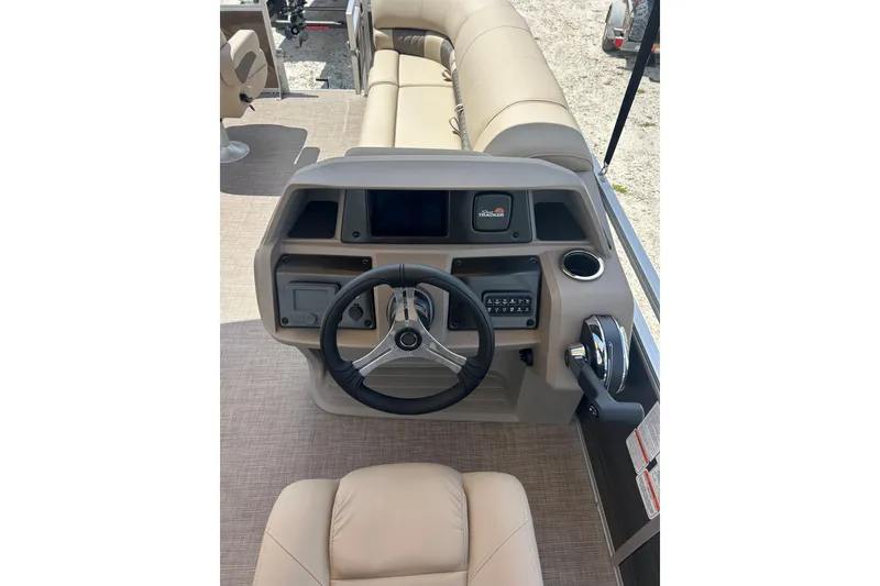 Slide: The Image of 2024 Sun Tracker SportFish 20 DLX boat dashboard with steering wheel and controls. - 2