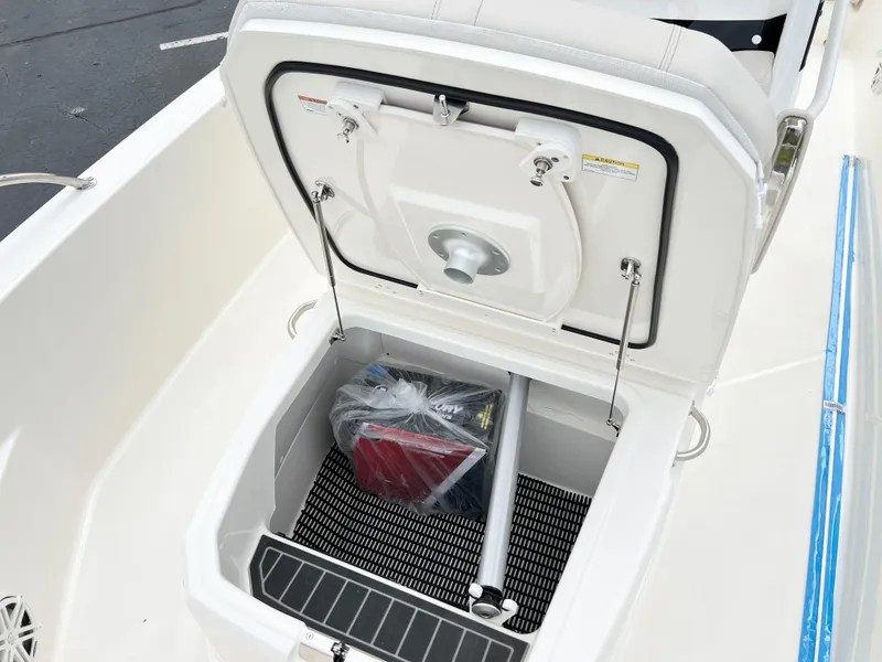 Slide: The Image of 2024 Boston Whaler 220 Dauntless storage compartment with open hatch. - 10