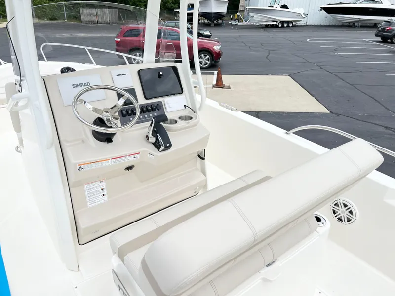 Slide: The Image of 2024 Boston Whaler 220 Dauntless boat console and seating area. - 4