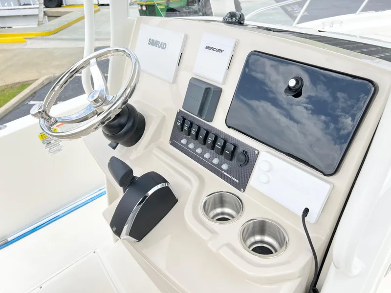 Slide: The Image of 2024 Boston Whaler 220 Dauntless helm with steering wheel, controls, and electronics. - 5