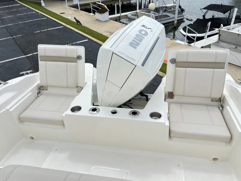 Slide: The Image of 2024 Boston Whaler 220 Dauntless boat with twin seats and outboard motor. - 6