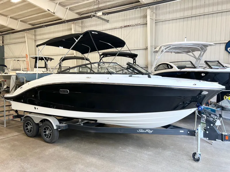 Slide: The Image of 2024 Sea Ray SPX 210 boat on trailer in indoor showroom. - 0