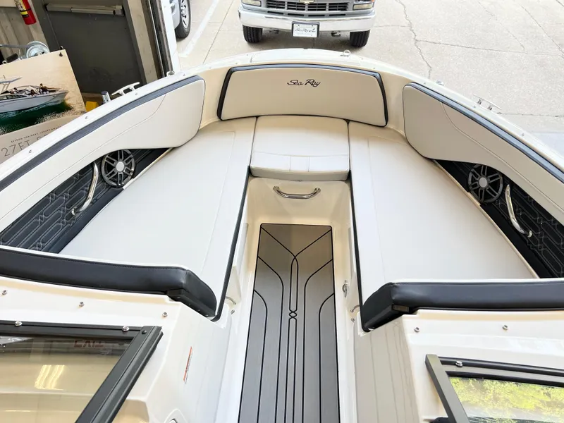 Slide: The Image of 2024 Sea Ray SPX 210 boat interior with white seating and black accents. - 2