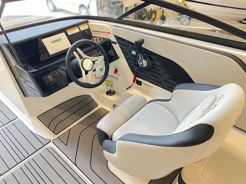 Slide: The Image of 2024 Sea Ray SPX 210 boat interior with steering wheel and captain's seat. - 4