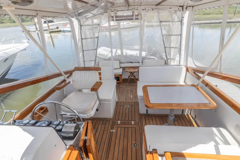 Slide: The Image of Interior of a 1990 Little Harbor 34 Express Direct Drive boat with wooden flooring and seating. - 1