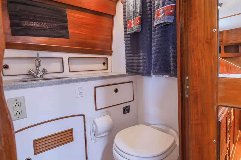 Slide: The Image of 1990 Little Harbor 34 Express Direct Drive boat bathroom with sink and toilet. - 10