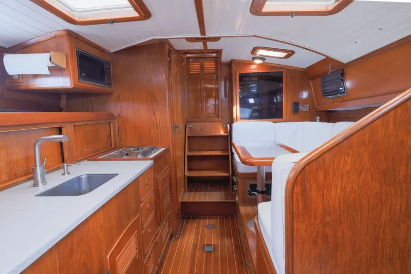 Slide: The Image of Interior of 1990 Little Harbor 34 Express Direct Drive yacht with wooden finishes and white seating. - 11