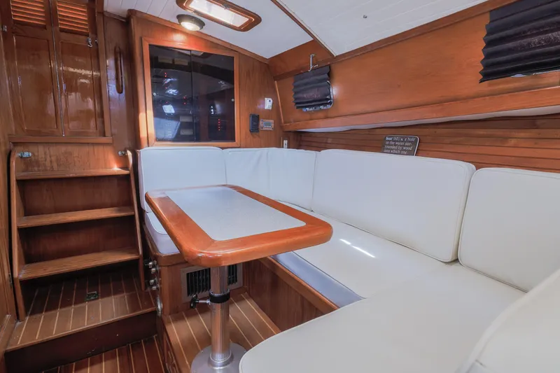 Slide: The Image of Interior of 1990 Little Harbor 34 Express Direct Drive with white seating and wooden accents. - 12