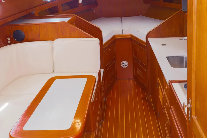 Slide: The Image of Interior of 1990 Little Harbor 34 Express Direct Drive yacht with wood finish and white seating. - 13
