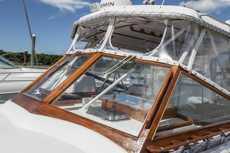 Slide: The Image of 1990 Little Harbor 34 Express Direct Drive boat with clear windshield and wooden trim. - 14