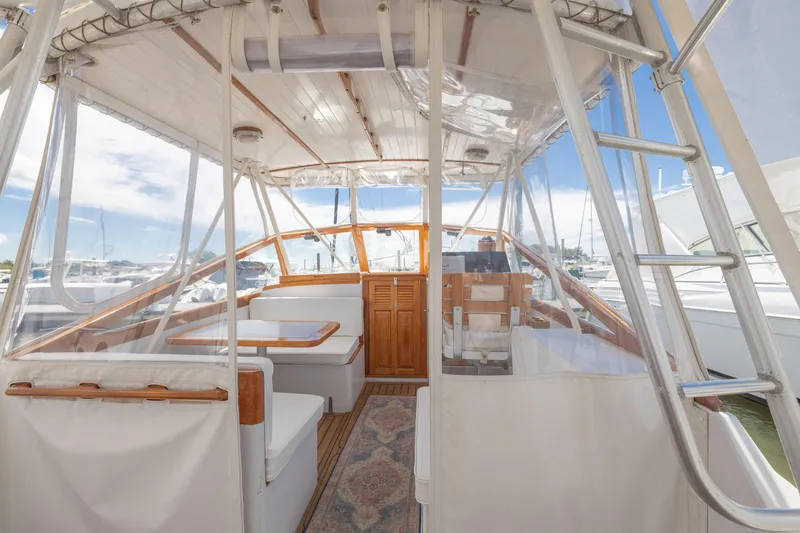 Slide: The Image of 1990 Little Harbor 34 Express Direct Drive boat interior with seating and helm. - 16