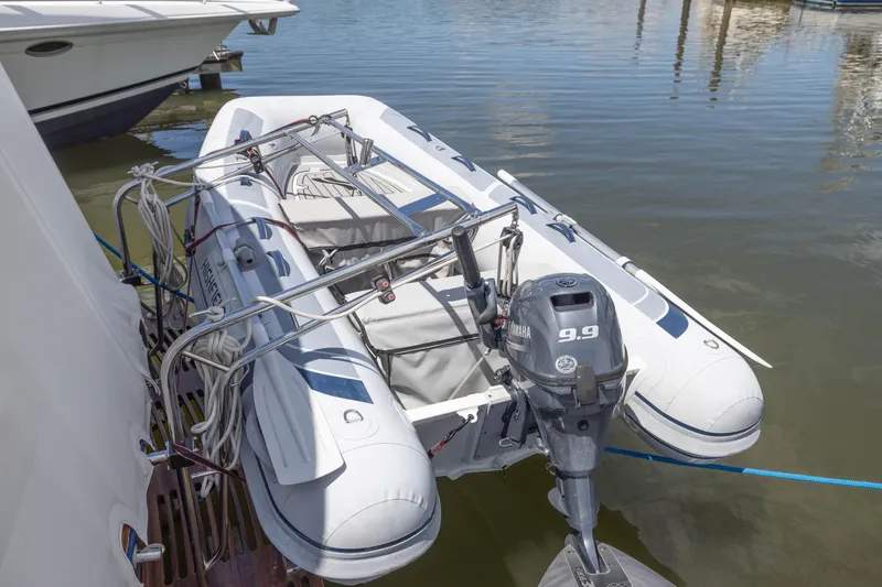 Slide: The Image of Inflatable dinghy with Yamaha 9.9 motor docked beside a 1990 Little Harbor 34 Express Direct Drive. - 20