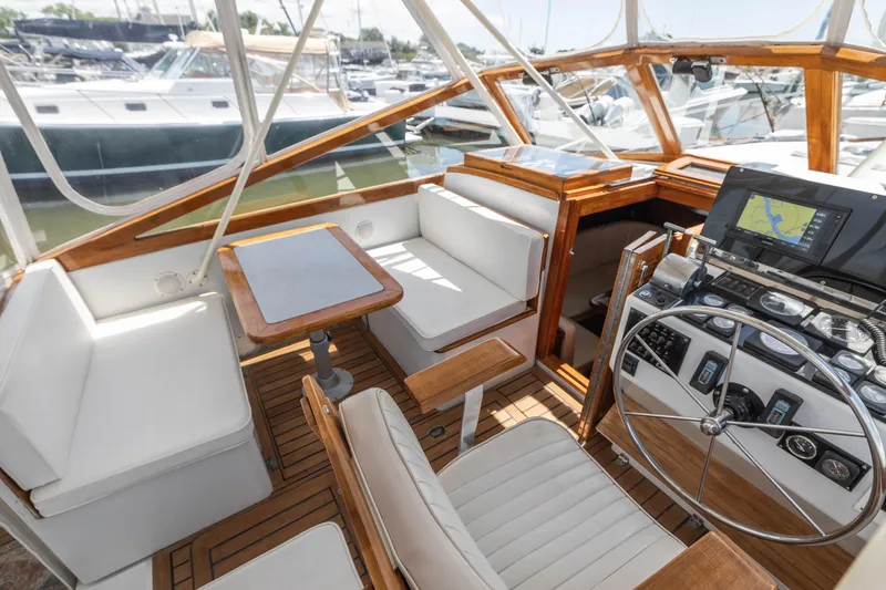 Slide: The Image of 1990 Little Harbor 34 Express Direct Drive boat interior with helm, seating, and navigation equipment. - 5