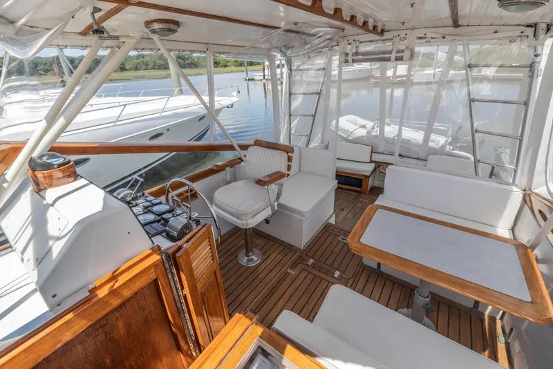 Slide: The Image of Interior of 1990 Little Harbor 34 Express Direct Drive boat with wooden accents and white seating. - 6