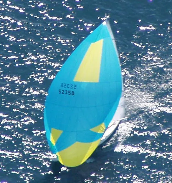 Slide: The Image of Aerial view of a 2005 Morris M36 sailboat with colorful spinnaker. - 1