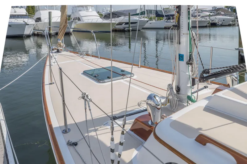 Slide: The Image of 2005 Morris M36 sailboat docked at a marina with other boats in the background. - 14
