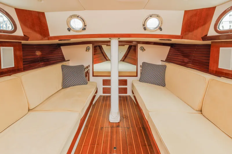 Slide: The Image of Interior of 2005 Morris M36 sailboat with wooden flooring and beige seating. - 16