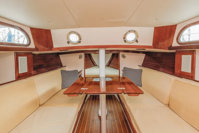 Slide: The Image of Interior of 2005 Morris M36 sailboat with wooden table and beige seating. - 17