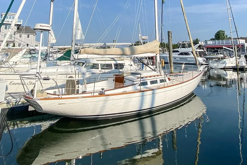 Slide: The Image of 2005 Morris M36 sailboat docked in a marina with other boats. - 22