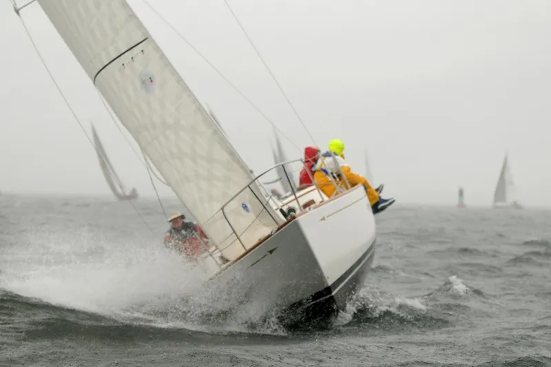 Slide: The Image of Sailboat Morris M36 2005 racing in rough sea conditions with crew in rain gear. - 3