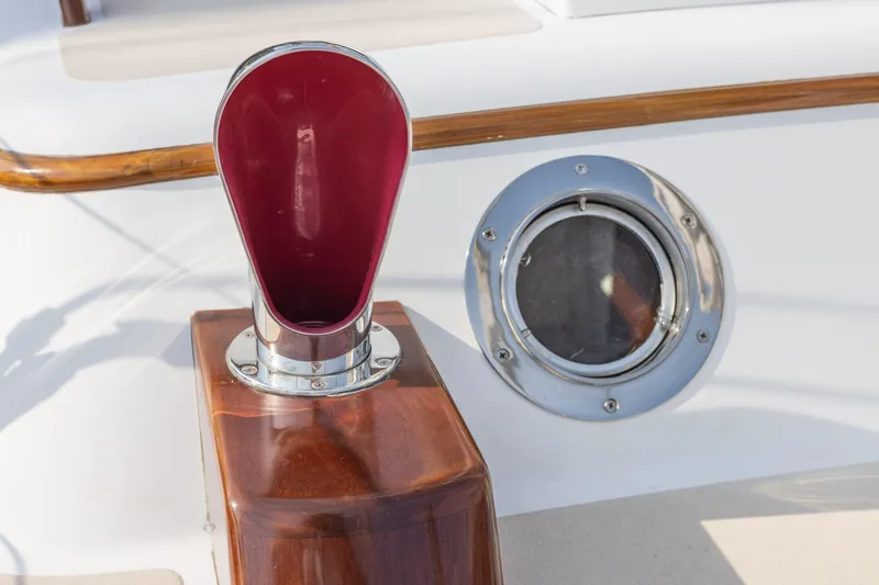 Slide: The Image of Close-up of a 2005 Morris M36 boat's deck details, featuring a polished wood finish and chrome accents. - 6
