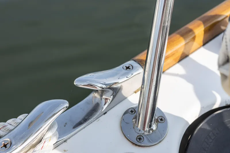 Slide: The Image of Close-up of a 2005 Morris M36 boat's polished metal cleat and railing. - 7