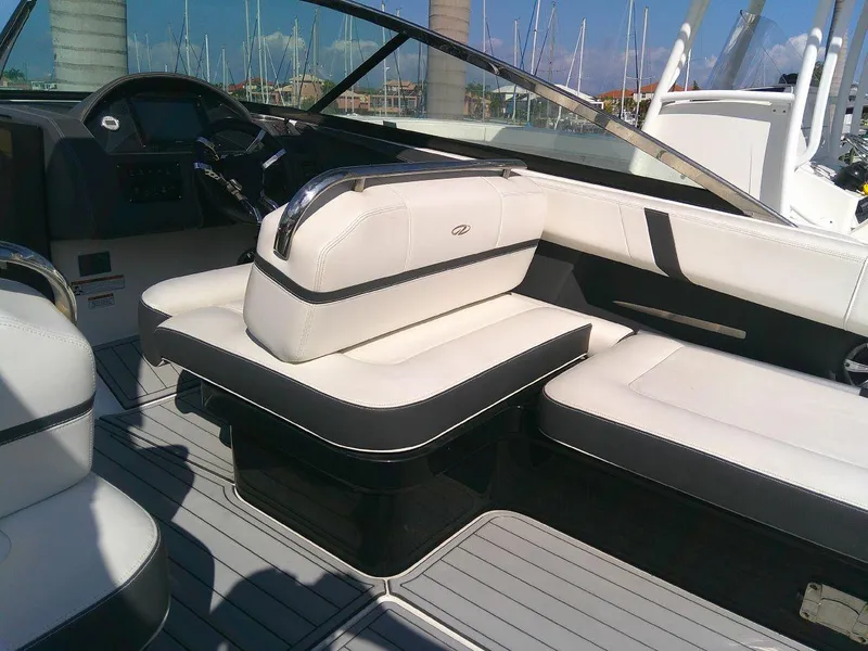 Slide: The Image of 2017 Regal 2800 Bowrider interior with white and black seating, docked at marina. - 15