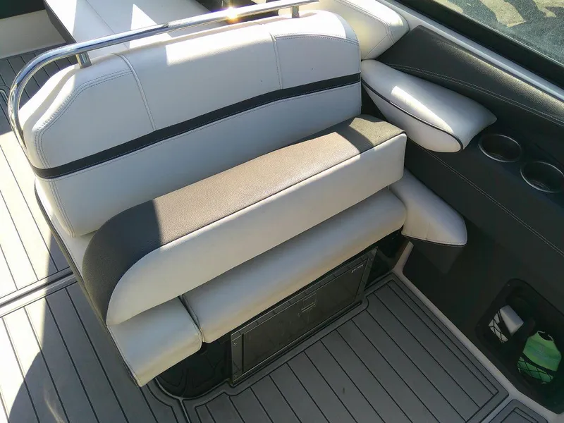 Slide: The Image of 2017 Regal 2800 Bowrider boat interior seating with gray upholstery and cup holders. - 20