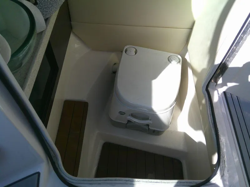Slide: The Image of 2017 Regal 2800 Bowrider boat interior with portable toilet. - 22