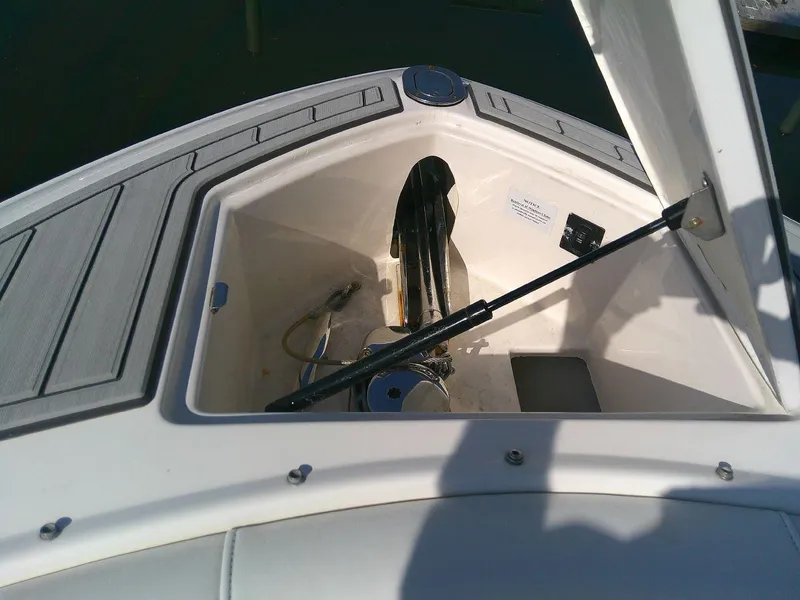 Slide: The Image of 2017 Regal 2800 Bowrider anchor storage compartment with open hatch. - 24