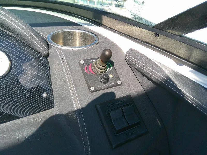 Slide: The Image of 2017 Regal 2800 Bowrider dashboard with joystick control and cup holder. - 27