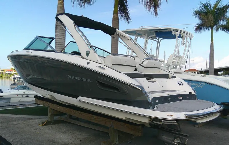Slide: The Image of 2017 Regal 2800 Bowrider boat docked near palm trees. - 4