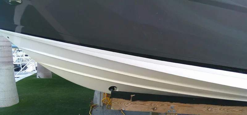 Slide: The Image of 2017 Regal 2800 Bowrider boat hull on a wooden stand. - 6