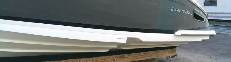 Slide: The Image of 2017 Regal 2800 Bowrider boat hull on a wooden stand. - 7