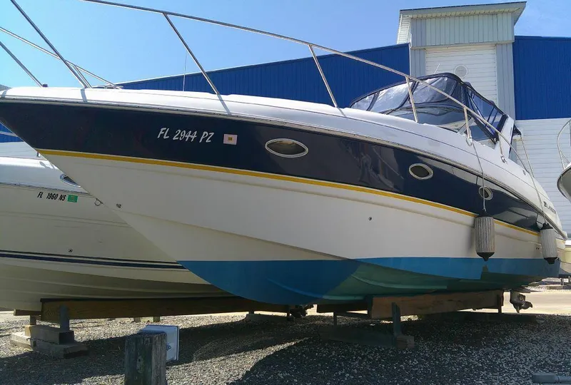 Slide: The Image of 2005 Larson Cabrio 330 boat on dry dock. - 0