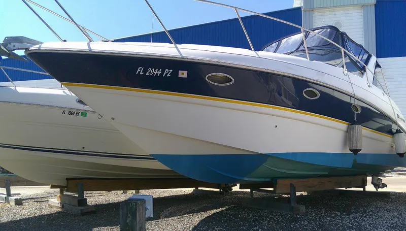 Slide: The Image of 2005 Larson Cabrio 330 boat on dry dock. - 1