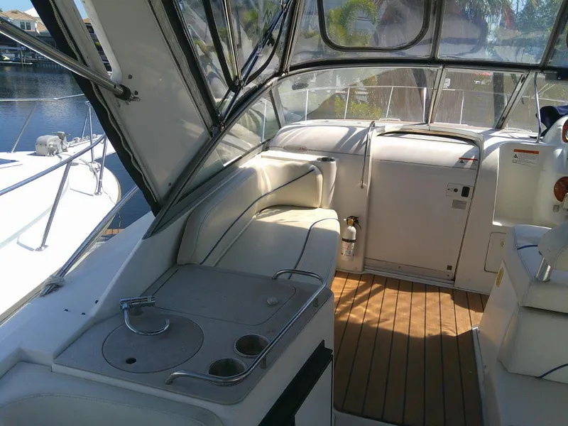 Slide: The Image of 2005 Larson Cabrio 330 boat interior with seating and kitchenette. - 15