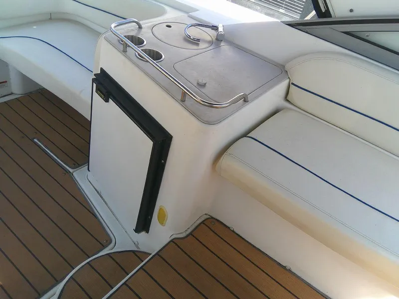 Slide: The Image of 2005 Larson Cabrio 330 boat interior with seating and kitchenette. - 17