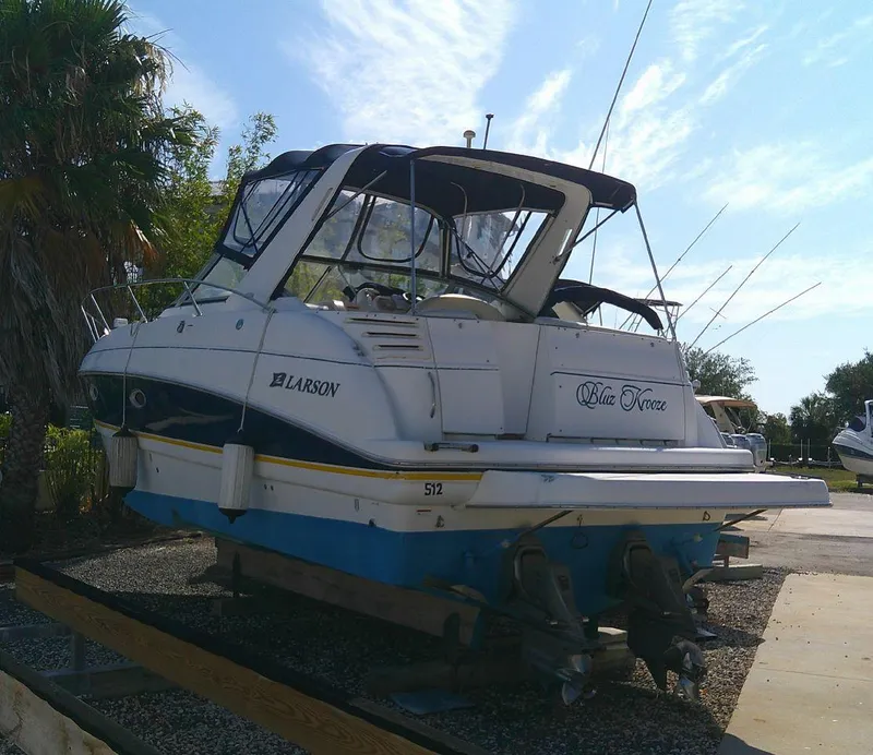 Slide: The Image of 2005 Larson Cabrio 330 boat on a trailer, named Blue Force. - 2