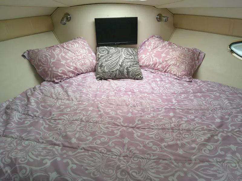 Slide: The Image of Cozy cabin bed in 2005 Larson Cabrio 330 boat with patterned bedding. - 20