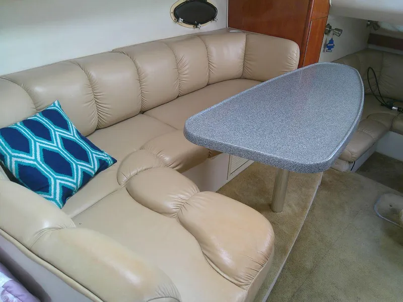 Slide: The Image of 2005 Larson Cabrio 330 interior with beige leather seating and a granite-style table. - 21
