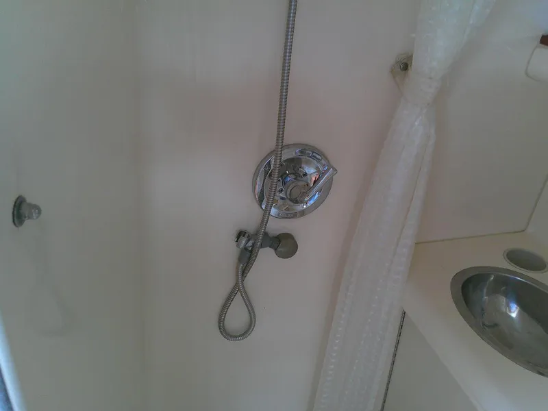 Slide: The Image of 2005 Larson Cabrio 330 boat bathroom with shower and sink. - 25