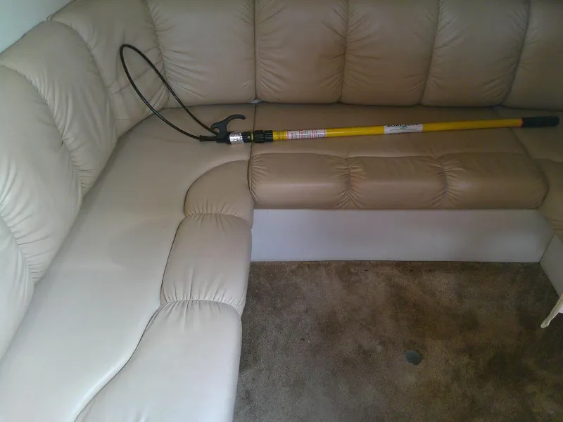 Slide: The Image of 2005 Larson Cabrio 330 interior with beige leather seating and a yellow tool. - 26