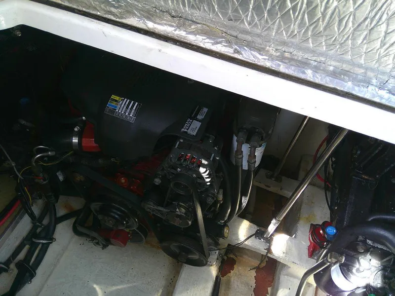 Slide: The Image of 2005 Larson Cabrio 330 engine compartment with visible components. - 32