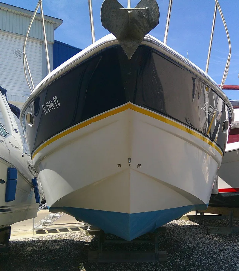 Slide: The Image of 2005 Larson Cabrio 330 boat on dry dock, front view. - 4